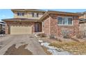 Charming two-story home features a brick and siding exterior, attached garage, and a well-maintained front yard at 247 N Coolidge Way, Aurora, CO 80018