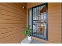 Close-up of the front door featuring decorative security door, lovely house plant, and views into the front entry at 2263 E 129Th Ave, Thornton, CO 80241