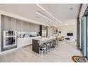Contemporary kitchen with sleek cabinetry, marble backsplash, large island and stainless steel appliances at 4200 W 17Th Ave # 1013, Denver, CO 80204