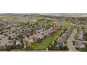 Aerial view of a home with manicured lawn in a residential neighborhood and close proximity to a green space at 4915 Parsons Way, Castle Rock, CO 80104