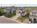 Aerial view of a home with manicured lawn in a residential neighborhood with mature trees and landscaping at 4915 Parsons Way, Castle Rock, CO 80104