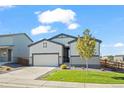 Charming single-story home with a well-manicured lawn and attached two-car garage at 1868 Homestead Dr, Fort Lupton, CO 80621