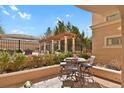 Inviting patio with seating area featuring outdoor pergola and lush landscaping, perfect for relaxation and entertaining at 2500 E Cherry Creek South Dr # 116, Denver, CO 80209