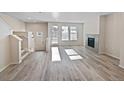 Bright living room featuring neutral paint, fireplace, and many windows letting in natural light at 591 Brennan Cir, Erie, CO 80516