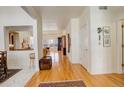 Hardwood floor hallway with view of living and dining area at 3016 Greensborough Dr, Highlands Ranch, CO 80129