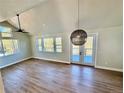 Bright living room with a fan, wood floors and multiple windows offering scenic views at 33884 Bergen View Trl, Evergreen, CO 80439