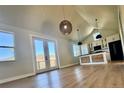 Bright living room boasts wood floors, modern lighting, and a mountain view at 33884 Bergen View Trl, Evergreen, CO 80439