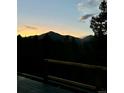 Sunset view over the mountains from a wood deck at 33884 Bergen View Trl, Evergreen, CO 80439