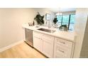 Bright kitchen boasting white cabinets, stainless steel sink, and modern countertops at 14006 E Stanford Cir # K08, Aurora, CO 80015