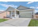 Single-Gathering home with a two-car garage, covered porch, and professional landscaping at 42338 Forest Oaks Dr, Elizabeth, CO 80107