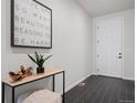 Modern foyer features tile flooring, a console table with decor, and a white front door at 42338 Forest Oaks Dr, Elizabeth, CO 80107
