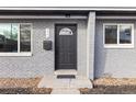Inviting front entrance with stylish gray brick, updated windows, and door at 2405 W 39Th Ave, Denver, CO 80211
