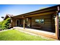 Inviting log home porch with a swing offers a relaxing outdoor space at 2965 Wagner St, Strasburg, CO 80136