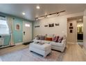 Bright living room with a cozy couch, soft lighting and a view of the bathroom at 120 S Pennsylvania St # 302, Denver, CO 80209