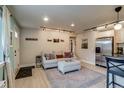 Comfortable living room with stylish couch, area rug, and modern decor leading to kitchen at 120 S Pennsylvania St # 302, Denver, CO 80209