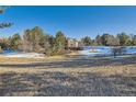House with a large backyard and surrounding trees at 5100 S Monaco St, Greenwood Village, CO 80111