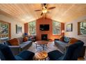 Inviting living room featuring a fireplace, vaulted ceilings, and large windows for natural light at 8722 S Ault Ln, Morrison, CO 80465