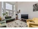 Bright living room with tall windows, hardwood floors, and stylish modern decor at 1600 S Quebec Way # 8, Denver, CO 80231