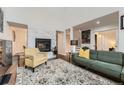 Cozy living room featuring a fireplace, hardwood floors, and comfortable modern furniture at 1600 S Quebec Way # 8, Denver, CO 80231