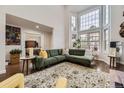 Spacious living room with a large window, hardwood floors, and comfortable modern decor at 1600 S Quebec Way # 8, Denver, CO 80231