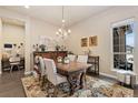 Bright dining room with a chandelier, view from the window, and area for a study at 15720 Columbus Mountain Dr, Broomfield, CO 80023