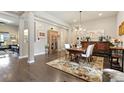 Open dining room with chandelier, hardwood floors and decoratively furnished at 15720 Columbus Mountain Dr, Broomfield, CO 80023