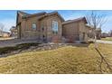 Side view of this home showing the professional landscaping and low maintenance yard at 15720 Columbus Mountain Dr, Broomfield, CO 80023