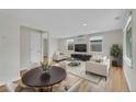 Bright living room featuring hardwood floors, neutral walls, and recessed lighting at 1720 Trenton St, Denver, CO 80220