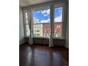 Charming views through large windows showcase the historic brick building, hardwood floors, and bright light at 720 16Th St # 306, Denver, CO 80202