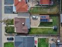 Bird's-eye view of property with green lawn, solar panels, driveway, and neighboring houses at 2235 W 46Th Ave, Denver, CO 80211