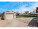 Detached garage with concrete driveway and gravel area, providing ample parking space at 2235 W 46Th Ave, Denver, CO 80211