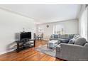 Inviting living room with hardwood floors, a cozy sofa, and a bright window at 2235 W 46Th Ave, Denver, CO 80211