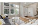 Bright living room with large windows, hardwood floors, and stylish contemporary furniture at 8652 Aberdeen Cir, Highlands Ranch, CO 80130