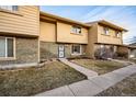 Inviting townhouse exterior showcasing brick accents, complemented by a well-manicured lawn at 1191 S Troy St, Aurora, CO 80012