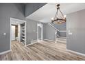 Spacious living room with wood plank flooring and a modern lighting fixture at 11103 E Alameda Ave # 201, Aurora, CO 80012