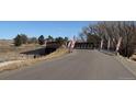 Asphalt road over bridge with promotional signs along the safety rail at 42994 Colonial Trl, Elizabeth, CO 80107