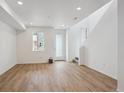 Bright, open-concept living area with modern wood flooring and fresh white walls at 1242 Penner Dr, Erie, CO 80026