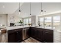 Bright open-concept kitchen featuring a large island, stainless steel appliances, and scenic outdoor views at 5424 Freddys Trl, Parker, CO 80134