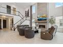 Bright living room with soaring ceilings, fireplace, sleek furniture, and stylish decor creates a welcoming space at 6263 E 142Nd Pl, Thornton, CO 80602
