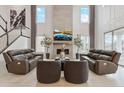 Bright living room with soaring ceilings, fireplace, sleek furniture, and stylish decor creates a welcoming space at 6263 E 142Nd Pl, Thornton, CO 80602
