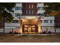 The Polo Club entrance is adorned with flags, planters, and a well lit entryway at 3131 E Alameda Ave # 1203, Denver, CO 80209