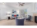 Cozy living room featuring a fireplace, comfortable seating, and sliding doors to the balcony at 8200 E 8Th Ave # 8101, Denver, CO 80230