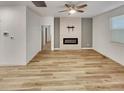 Bright, modern living room featuring a fireplace and hardwood floors at 4877 Cattle Cross Rd, Castle Rock, CO 80104