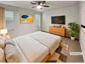 Comfortable staged primary bedroom with natural light, neutral carpet, and a ceiling fan at 4877 Cattle Cross Rd, Castle Rock, CO 80104