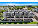Aerial view showcasing modern townhomes with rooftop decks in a vibrant urban setting at 3308 W 17Th Ave, Denver, CO 80204