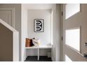 Bright entryway features modern decor, including a bench, sleek artwork, and a stylish door at 3308 W 17Th Ave, Denver, CO 80204