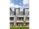 Contemporary townhome showcasing modern architecture, brick facade, and sleek balconies at 3308 W 17Th Ave, Denver, CO 80204