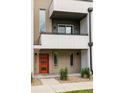 Close-up of modern townhome showcasing stylish brick facade, modern lighting, and an orange front door at 3308 W 17Th Ave, Denver, CO 80204