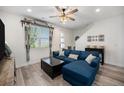 Cozy living room with a comfortable blue sectional, stylish decor, and natural light at 7877 Yampa River Ave, Littleton, CO 80125