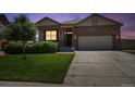 Charming single-Gathering home with a well-manicured lawn and inviting front entrance, plus a two car garage at twilight at 8020 E 136Th Dr, Thornton, CO 80602